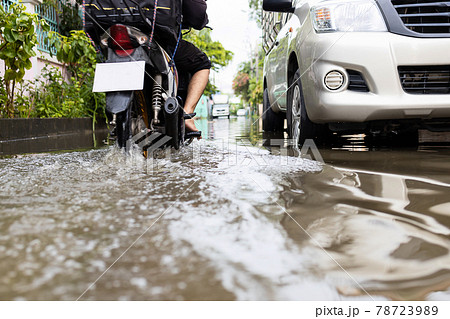 Flooded car vehicles after heavy rain,street in the alley were covered with a large amount of water,drainage problems,traffic problems due to flooding on the road 78723989