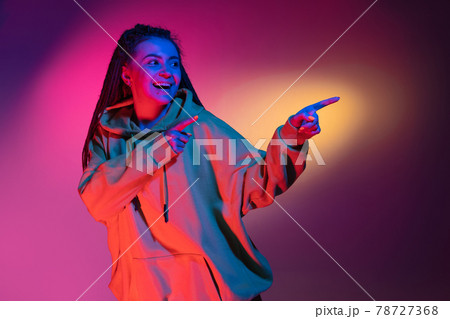 Young woman's portrait on gradient colors studio background in neon. Concept of human emotions. Young woman's portrait on gradient colors studio background in neon. Concept of human emotions. 78727368