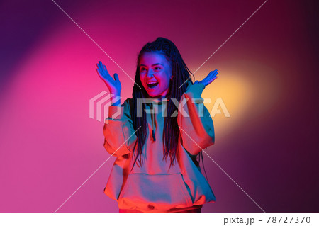 Young woman's portrait on gradient colors studio background in neon. Concept of human emotions. Young woman's portrait on gradient colors studio background in neon. Concept of human emotions. 78727370
