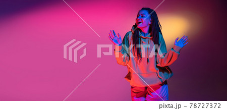 Young woman's portrait on gradient colors studio background in neon. Concept of human emotions. Young woman's portrait on gradient colors studio background in neon. Concept of human emotions. 78727372