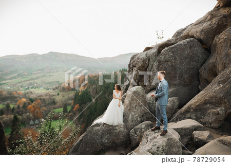Loving husband and woman on the background of the mountains. Loving couple emotionally spends time 78729054