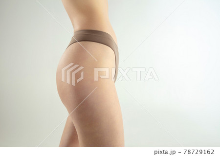 Perfect slim toned young body of the girl or fit woman at studio