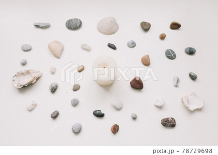 Spa background with sea shells and pebbles and white candle on white. Flat lay, top view, minimal spa concept 78729698