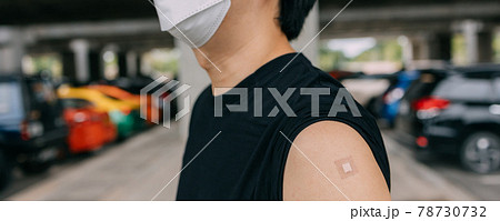 Young vaccinated man showing arms with adhesive plaster bandage after receiving Covid-19 vaccine injection Young vaccinated man showing arms with adhesive plaster bandage after receiving Covid-19 vaccine injection 78730732