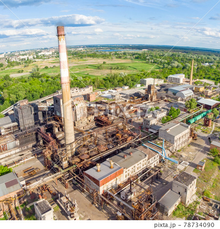Aerial drone shot of old industrial zone with smoke stack. Air pollution concept Aerial drone shot of old industrial zone with smoke stack. Air pollution concept 78734090