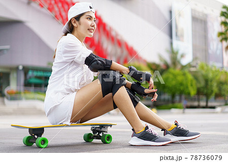 Hello Summer Surfers people Asian having fun with surfboards or surf skate around city streets background on a summer day. Free relax lifestyle and millennial trend concept 78736079