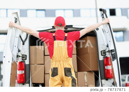 Male courier opening minivan car with many cardboard boxes Male courier opening minivan car with many cardboard boxes 78737871
