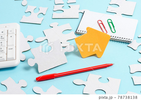 Close-Up White Jigsaw Pattern Puzzle Pieces To Be Connected With Missing Last Piece Positioned On A Flat Lay Background With Different Texture And Paper Supplies Accesories Close-Up White Jigsaw Pattern Puzzle Pieces To Be Connected With Missing Last Piece Positioned On A Flat Lay Background With Different Texture And Paper Supplies Accesories 78738138