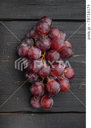 Natural organic juicy grapes, dark red fruits, on black wooden table , top view flat lay Natural organic juicy grapes, dark red fruits, on black wooden table , top view flat lay 78738174