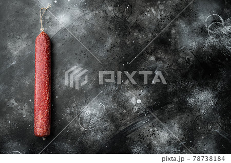 Salami sausage, on black dark stone background, top view flat lay, with copy space for text Salami sausage, on black dark stone background, top view flat lay, with copy space for text 78738184