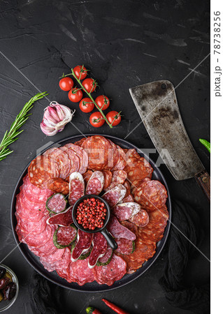Spanish cold meat plate, chorizo, fuet, lomo,longaniza and salchichon on balck background, top view Spanish cold meat plate, chorizo, fuet, lomo,longaniza and salchichon on balck background, top view 78738256