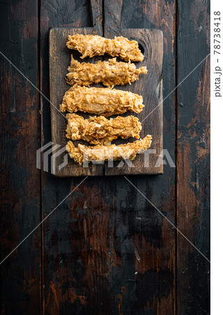 Chicken breaded breast on dark wooden background, flat lay, with space for text 78738418
