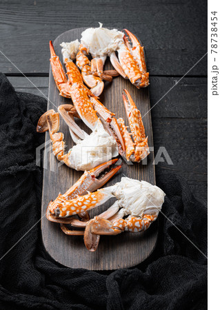 Boiled blue swimming crab parts, on black wooden table background 78738454