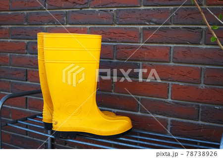 rubber boots near the entrance to the house rubber boots near the entrance to the house 78738926
