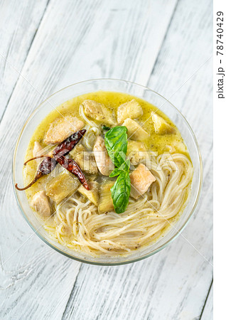Bowl of green curry with noodles 78740429