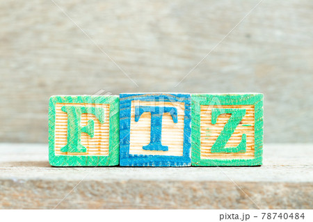 Color alphabet letter block in word FTZ (Abbreviation of Free trade zone) on wood background 78740484