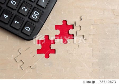 Close-Up White Jigsaw Pattern Puzzle Pieces To Be Connected With Missing Last Piece Positioned On A Flat Lay Background With Different Texture And Paper Supplies Accesories Close-Up White Jigsaw Pattern Puzzle Pieces To Be Connected With Missing Last Piece Positioned On A Flat Lay Background With Different Texture And Paper Supplies Accesories 78740673