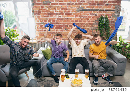 High angle view of young people watching TV, sport match together. Concept of friendship, leisure activity, emotions 78741456