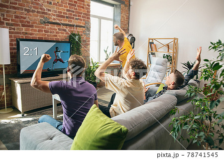 Group of friends watching TV, sport match together. Concept of friendship, leisure activity, emotions Group of friends watching TV, sport match together. Concept of friendship, leisure activity, emotions 78741545