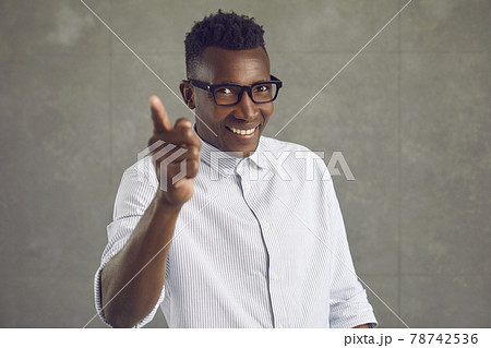 Happy handsome black man smiling and doing You're Right gesture isolated on gray background 78742536