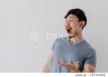 Shocked and surprised face of man in blue t-shirt isolated on white background. Shocked and surprised face of man in blue t-shirt isolated on white background. 78745006