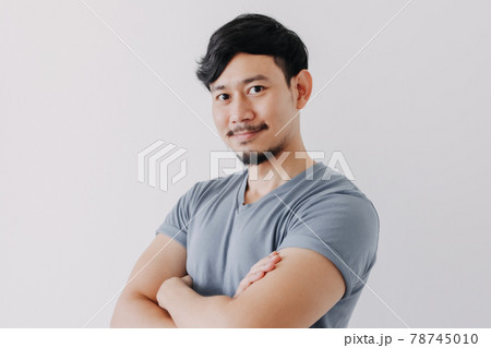 Confident and happy man in blue t-shirt isolated on white background. 78745010