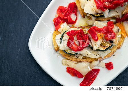 corn bread with cod fish and courgette on white dish 78746004