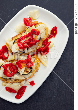 corn bread with cod fish and courgette on white dish 78746008