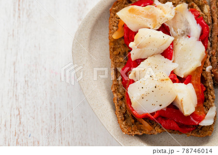 corn bread with cod fish and courgette on white dish 78746014