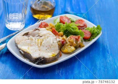 boiled fish with vegetables and fresh salad on white dish 78746132