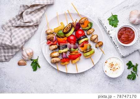 Vegetarian skewers with different grilled vegetables. Vegetarian skewers with different grilled vegetables. 78747170