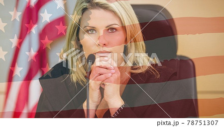 Waving american flag against portrait of caucasian female judge sitting in the court room 78751307