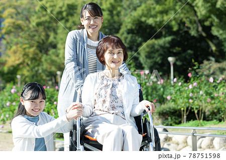 車椅子に座る祖母と笑顔の母娘 78751598
