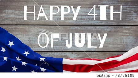 Happy independence day text and american flag against wooden background Happy independence day text and american flag against wooden background 78756189