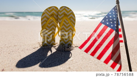 Composition of american flag and flip flops on beach 78756588