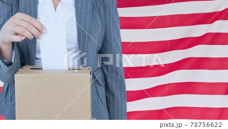 Composition of woman casting vote into ballot box against american flag 78756622