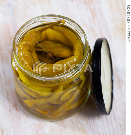 Glass jar with pickled green hot pepper 78758705