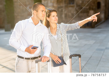Couple of tourists admiring city views while traveling Couple of tourists admiring city views while traveling 78758737