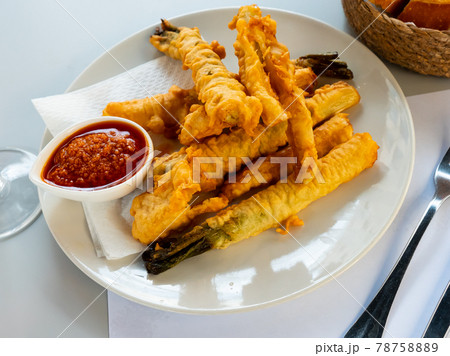 Tempura fried calcots served with Romesco sauce 78758889