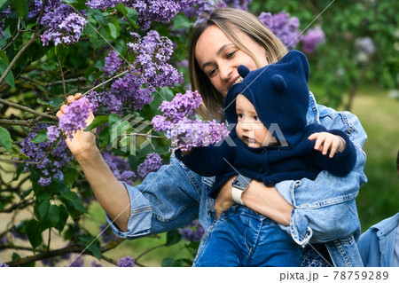 happy mother and son in the garden of blooming lilacs happy mother and son in the garden of blooming lilacs 78759289