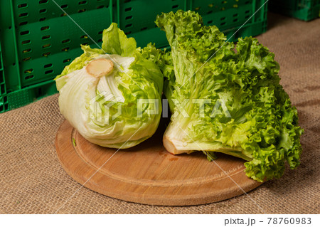 green lettuce leaves and head lettuce lie on the table, close-up shot, concept 78760983