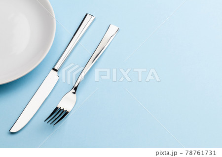 Empty plate, fork and knife Empty plate, fork and knife 78761731