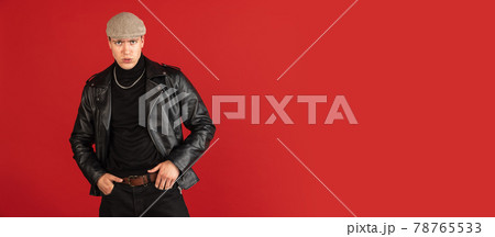 Young male portrait isolated on red studio background with copyspace for ad. Flyer 78765533