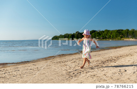 happy baby girl running on summer beach 78766215