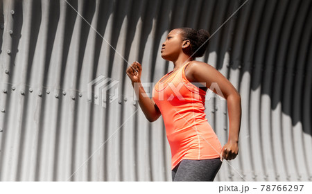 young african american woman running in tunnel 78766297