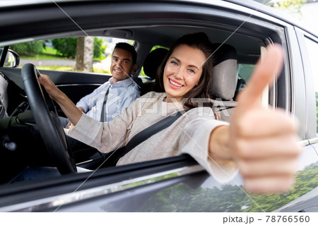 car driving instructor and woman showing thumbs up 78766560