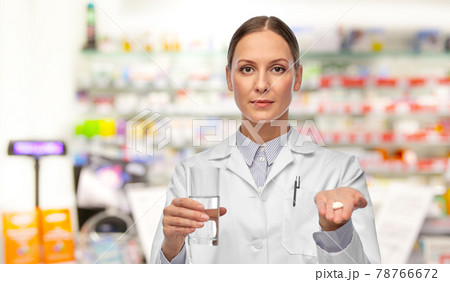 female doctor with medicine and glass of water female doctor with medicine and glass of water 78766672