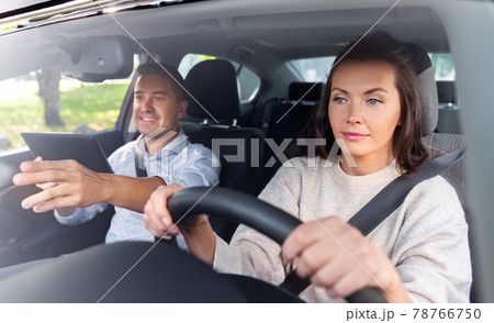 woman and driving school instructor in car 78766750