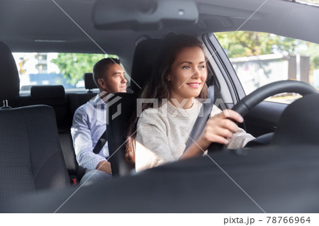 female driver driving car with male passenger female driver driving car with male passenger 78766964
