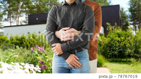 close up of hugging male gay couple at garden close up of hugging male gay couple at garden 78767019
